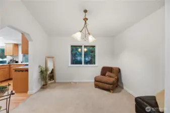 A bright dining room features vaulted ceilings with plenty of space for everyone!