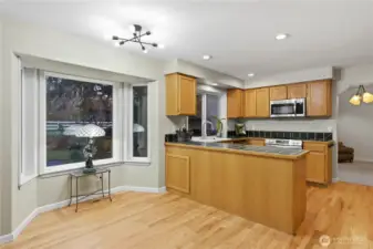 A generous eating nook filled with natural light and backyard views. Enjoy seamless flow from kitchen to family room.