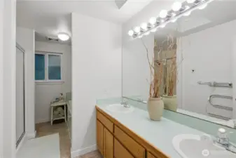 En suite primary bath with double sinks and plenty of counter space designed for comfort and convenience