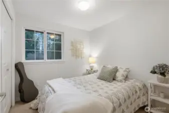 A generous bedroom with soft natural light. peaceful and welcoming.