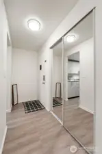 The entry showcases the nice laminate flooring and there is a large coat/storage closet