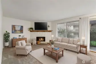 The open living room features a cozy fireplace with charming wood mantle & overlooks the tranquil courtyard. Newer carpeting expands through the space. *Photo virtually staged