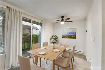 The dining space features a decorative ceiling fan light and also overlooks the courtyard. *Photo virtually staged.