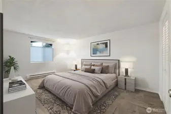 The primary suite is spacious with a walk-in closet leading to the attached bath. *Photo is virtually staged