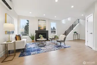 Good size Living room with multiple windows and metal stair case railing to 2nd level