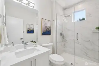 Main floor bathroom with tile surrounding all the way to the 9 ft ceiling