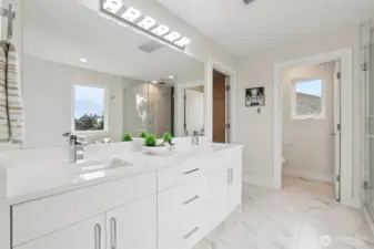 Primary Bathroom with tile floors and quartz countertops complementing designer cabinets