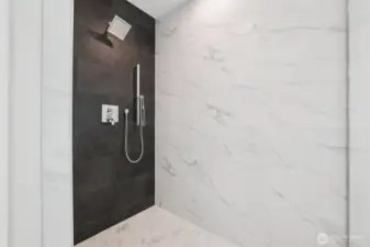 Yes this is primary bathroom with glass enclosure and tiled walls to the ceiling