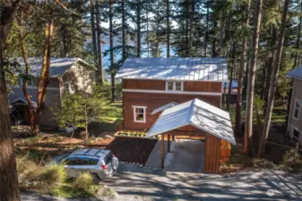 Detached carport, parking space and level front yard on north side of the home.