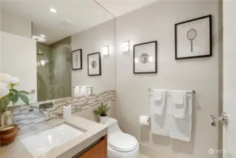 Jr. Suite Bathroom This stylish guest bathroom combines modern design with practical features. The elegant vanity and contemporary fixtures are complemented by the chic tiled shower. Every detail has been thoughtfully designed to offer comfort and sophistication.