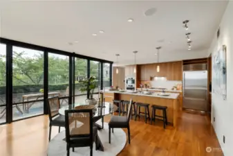 Dining Area: Entertain in style in this inviting dining area, where modern design meets natural beauty. Large windows offer picturesque views, creating a serene backdrop for your gatherings. The sleek kitchen island and high-end appliances make hosting a pleasure, ensuring every meal is a memorable experience.