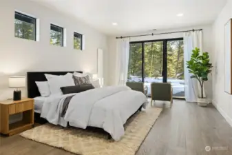 Primary bedroom with private slider leading out to back patio and gas firepit.