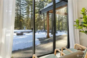 Primary bedroom with private slider leading out to back patio and gas firepit.