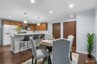 Table dining or breakfast bar? Large pantry closet and garage door in the background.