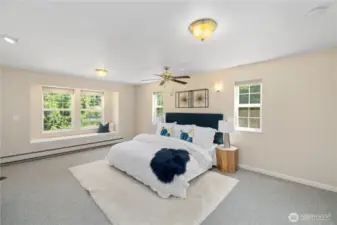 The oversized prime bedroom has storage under the window seat and the controls for the exterior security lights