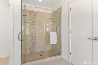 Walk-in shower in primary suite has two shower heads