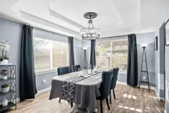 Formal dining area with beautiful chandelier. Large windows bring in lots of natural lighting to the space.