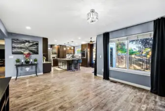 Large window brings in abundant natural light and looks out to back patio space. Open floor plan from family room to kitchen area.