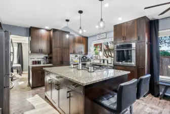 Large kitchen island with modern lighting overhead