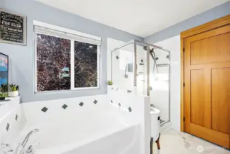 Primary en-suite bathroom looking toward walk-in closet