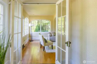 Glass French doors separate the space while still allowing enjoyment of the light and feel of home.