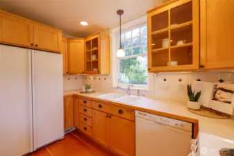 Great lighting, green views and gleaming wood give this kitchen a cheery countenance.
