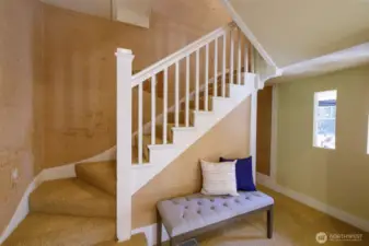 Gracious access to the upstairs in the center of the home leads to the remaining three bedrooms & second full bath.