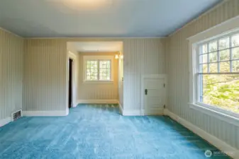 First of three bedrooms --this one with windows peeking out the front of the home...