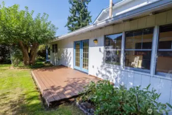 Back outside - a deck sits off the family room for al fresco meals or just enjoying the backyard ringed with established plantings (and what it rumored to be one of the oldest apple trees in the neighborhood!)