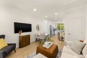 Sunlit open-concept living area designed for comfort and connection, featuring sleek finishes and warm hardwood tones.