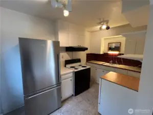 Movable dishwasher on right, tile back splash,