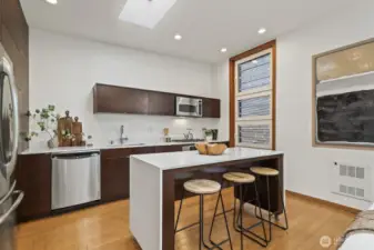 A large island anchors the kitchen and offers room to gather, enjoy leisurely morning coffee, or watch the chef at work.