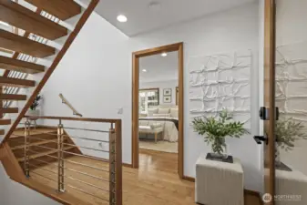 A gorgeous floating staircase acts as a centerpiece for the home. Head down from the main living areas to the primary suite.