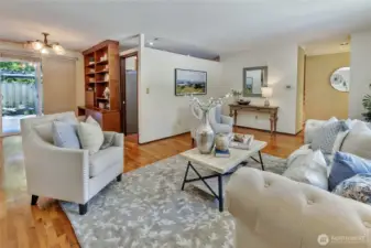 Living room look back towards the front door and towards the kitchen.