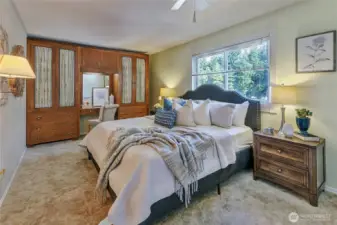 Primary bedroom with built in vanity cabinetry.