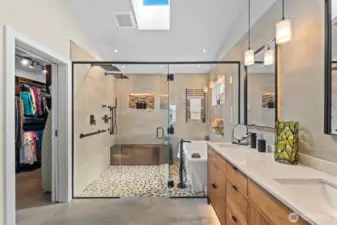 Primary bathroom with radiant heated floors throughout, including the vanity area, shower floor, and the tile bench inside the shower room for ultimate comfort.