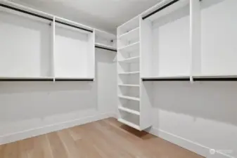 Spacious walk-in closet equipped with custom built-in organizers, offering ample storage and organization for your wardrobe and accessories