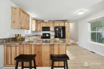 Ample, Pine kitchen Cabinet with breakfast eating area.