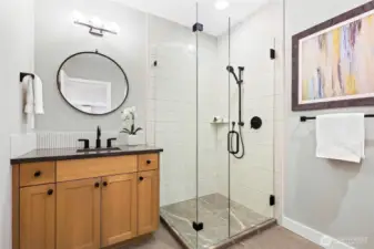 Main floor bathroom with shower is adjacent to the main floor bedroom.