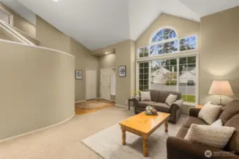 View of Living Room showing Front Door and Closet. Vaulted Ceiling & Double Pane Windows