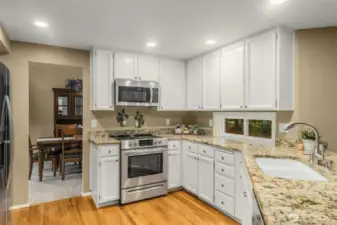 Kitchen with White Cabinets and Granite Counters. Fridge & Dishwasher replaced in 2024