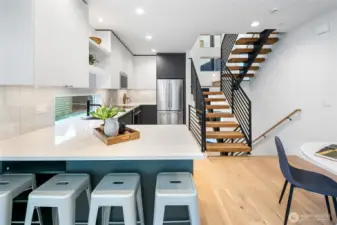 Pull up a stool at the waterfall-edge peninsula and picture weeknight dinners or Saturday-brunch mimosas served straight from the sleek KitchenAid range behind you. Photos are of model home 2009B.