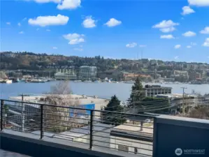 Lean on the railing and trace rowers cutting across the water while seaplanes rise toward the Olympic Mountains. Photos are of model home 2009B.