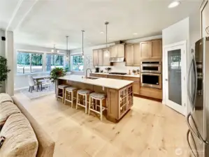 Kitchen offers wonderful gathering space with room for a crowd.  Gorgeous, engineered hardwood floors and beautiful cabinetry and stainless appliances with gas cooktop make this the perfect place to create culinary delights.
