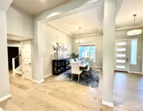 Looking towards dining from kitchen and entry. Stairs to bonus room to the left.