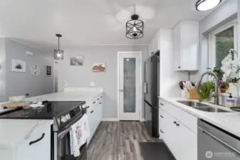 Another view of kitchen, pantry door straight ahead.
