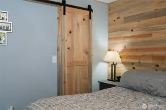 Primary bedroom closet with sliding barn door.