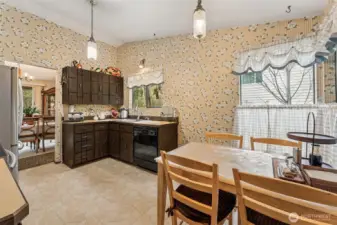 Original kitchen and eating nook looking out to formal dining area.