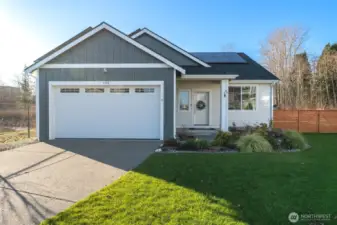Better-than-new single-level home with modern farmhouse styling, solar panels, and a welcoming covered entry.