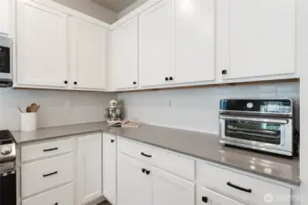 Extended counter space with ample storage and upgraded pull-out cabinetry for added convenience.